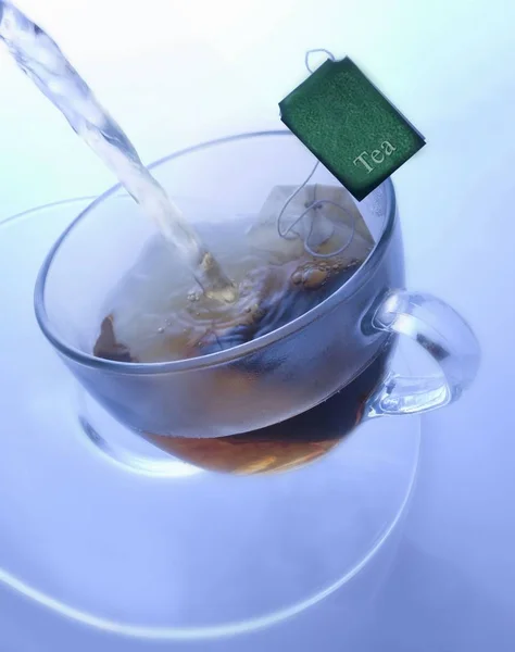 Glass cup with tea bag — Stock Photo, Image