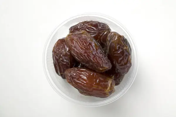 Dried dates in plastic dish — Stock Photo, Image