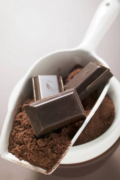 Chocolate and cocoa powder in scoop — Stock Photo, Image