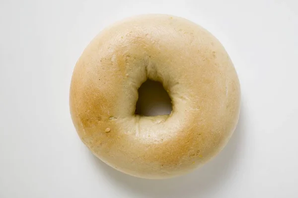 Fresh bagel on white surface — Stock Photo, Image