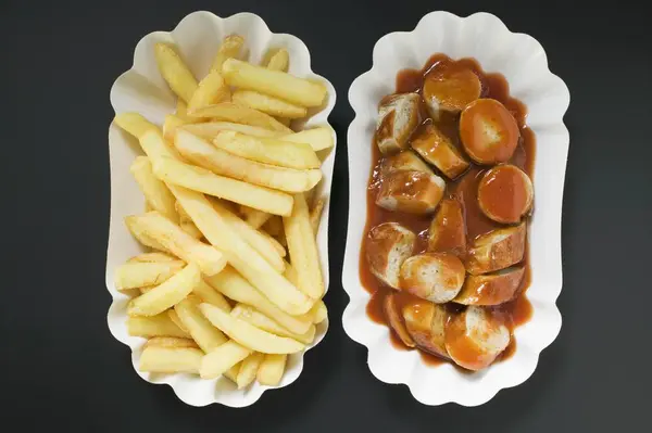 Sausage with ketchup and chips — Stock Photo, Image