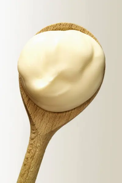 Bio-yoghurt on spoon — Stock Photo, Image