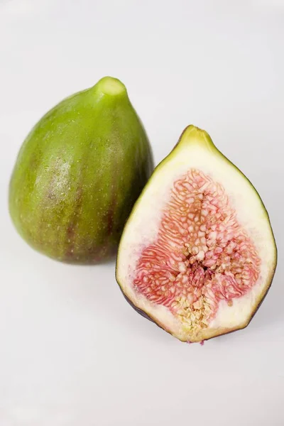 Whole and one halved figs — Stock Photo, Image