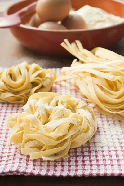 Three dried ribbon pasta nests — Stock Photo, Image