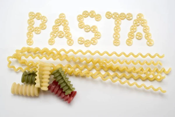 Word Pasta of wheel pasta pieces — Stock Photo, Image