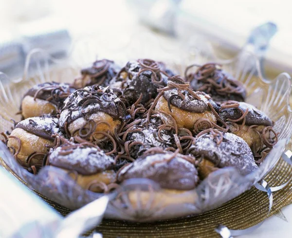 Profiteroles with chocolate in glass bowl — Stock Photo, Image