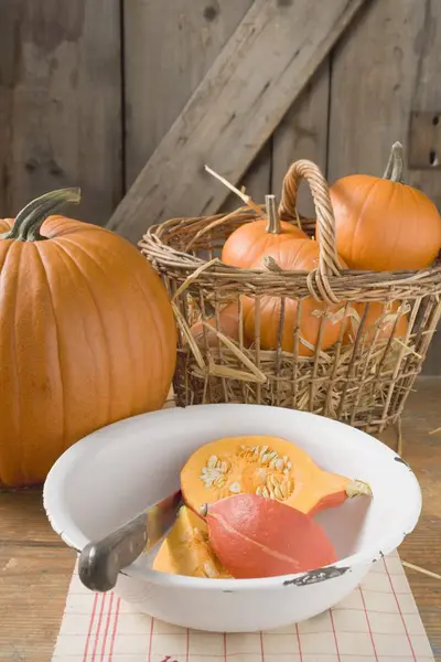Rustic pumpkins in basket — Stock Photo, Image