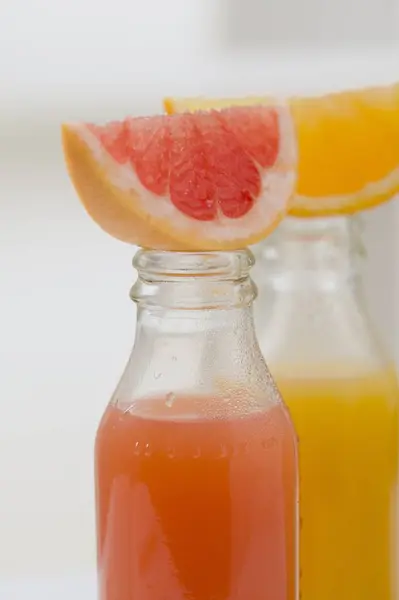 Three fruit juices in bottles — Stock Photo, Image