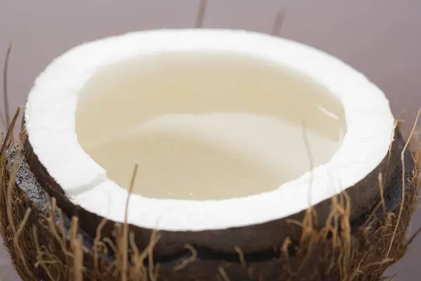 Half of coconut with water — Stock Photo, Image