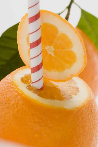 Orange fruit with straw — Stock Photo, Image