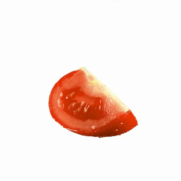 Tomato wedge with drops of water — Stock Photo, Image