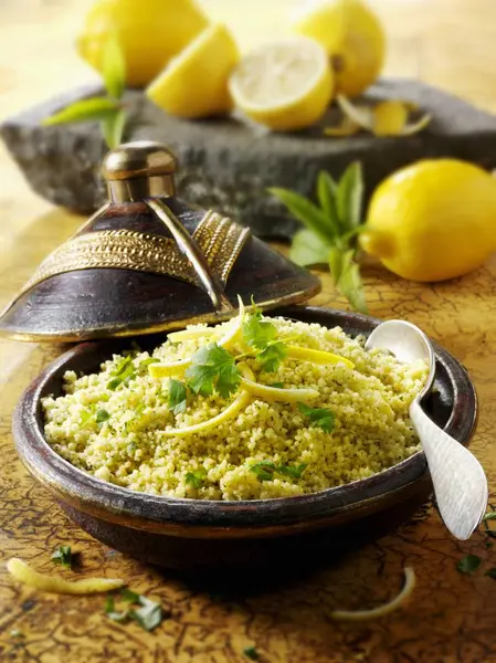 Couscous with lemons served in vintage wok — Stock Photo, Image