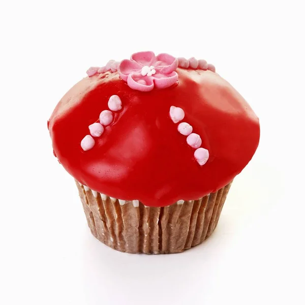 Muffin with red icing — Stock Photo, Image