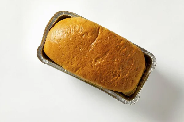Brioche bread in aluminium baking dish — Stock Photo, Image