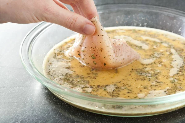 Human hand Dipping Chicken in Egg — Stock Photo, Image