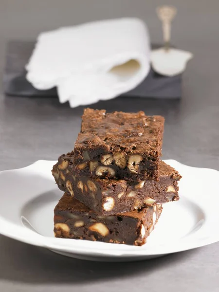 Stack of chocolate brownies with nuts — Stock Photo, Image