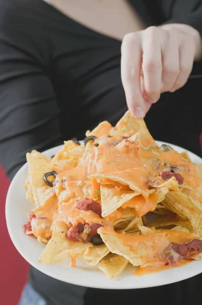 Frau greift nach Nachos — Stockfoto