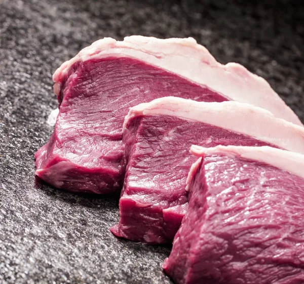 Three raw steaks — Stock Photo, Image