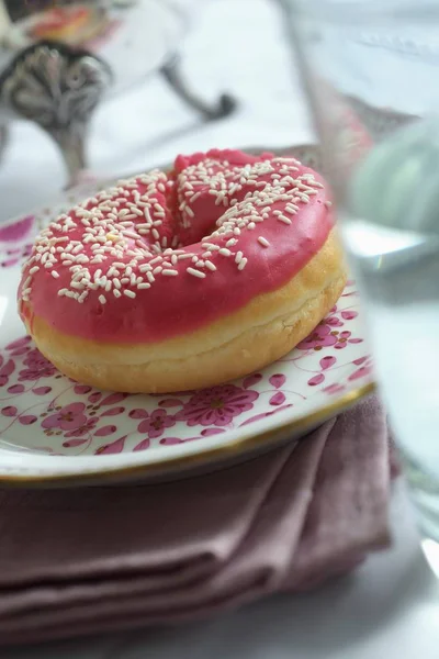 Doughnut decorated with pink icing — Stock Photo, Image