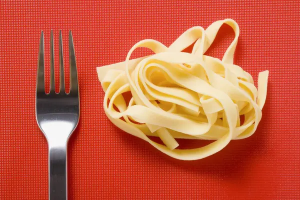 Tagliatelle pasta and fork — Stock Photo, Image