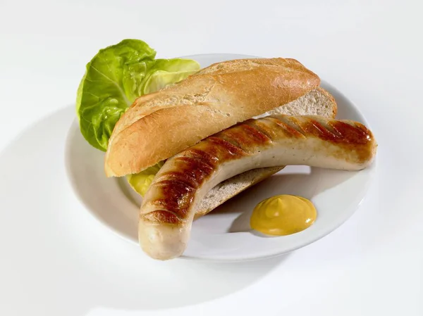 Grilled sausage in bread roll — Stock Photo, Image