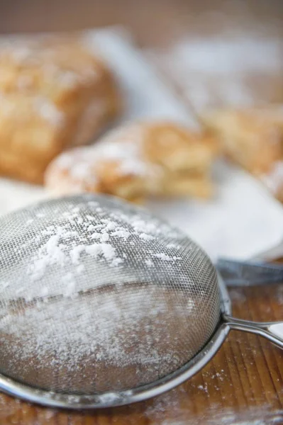 Closeup View Sieve Icing Sugar Baked Pastries Background — Stock Photo, Image