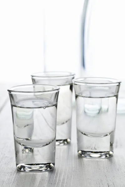 Vista Cerca Tres Vasos Ouzo Con Jarra Agua —  Fotos de Stock