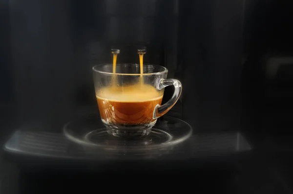 Coffee flowing from espresso machine — Stock Photo, Image