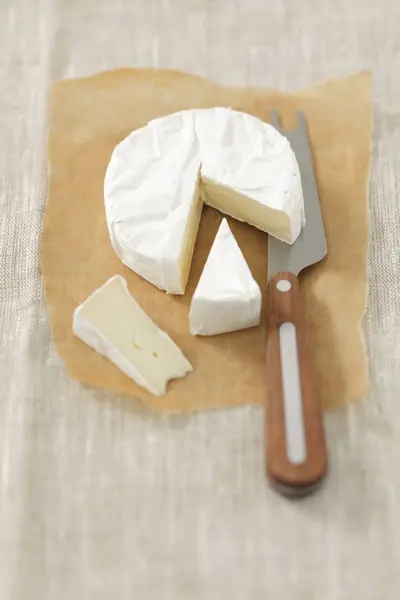 Partly sliced Camembert cheese — Stock Photo, Image