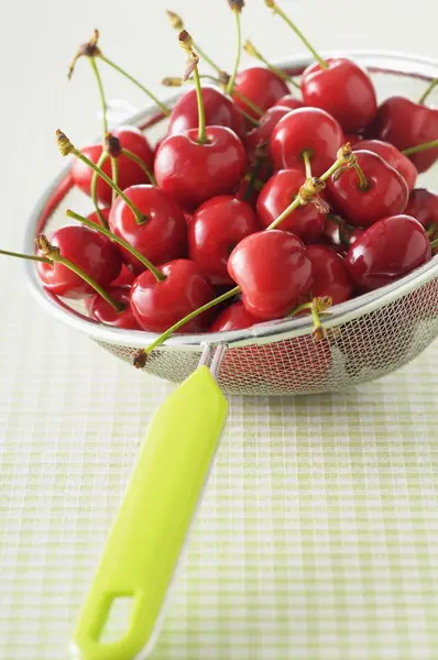 Fresh cherries in sieve — Stock Photo, Image