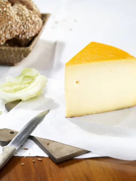 Gouda cheese on paper — Stock Photo, Image