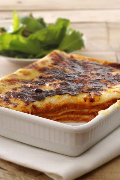 Cut baked lasagne in baking dish — Stock Photo, Image