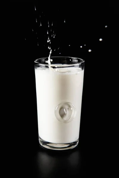 Glass of milk with splash — Stock Photo, Image