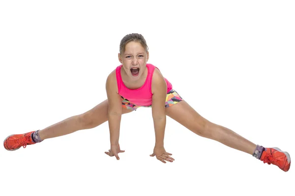 Young girl doing painful stretches on a white background. — Stock Photo, Image