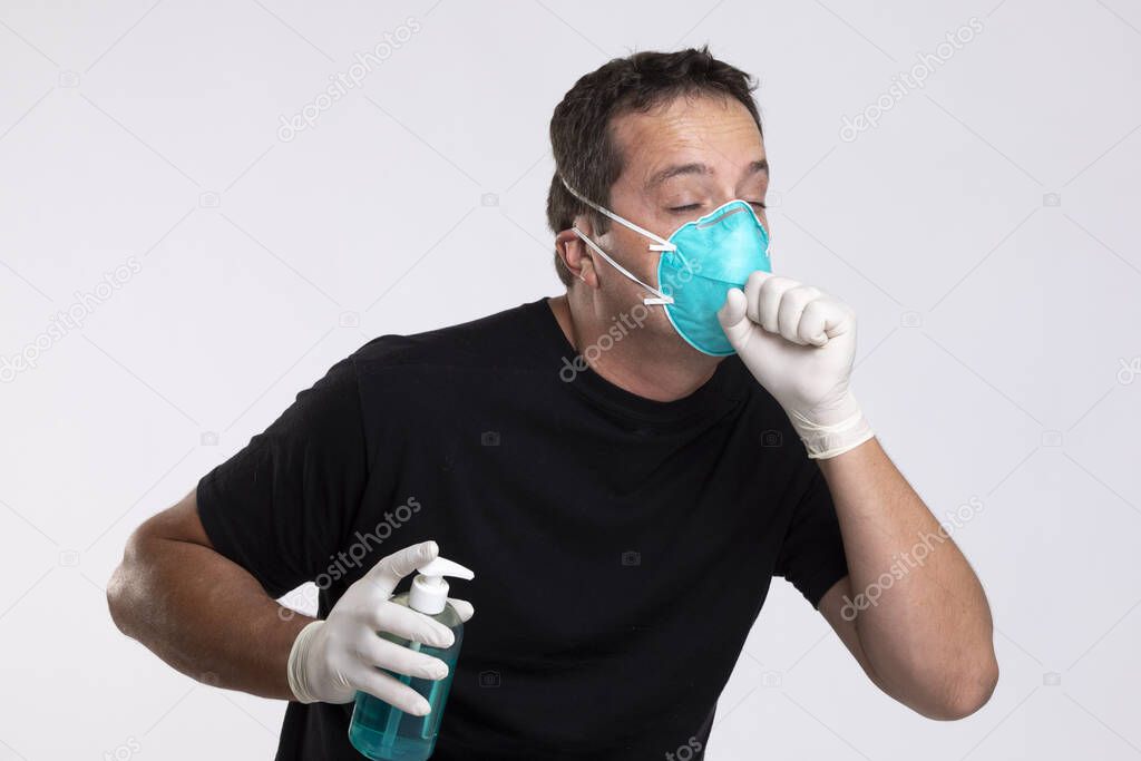 Sick man in mask with hand sanitizer coughing.