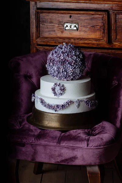 big violet cake costs on a chair