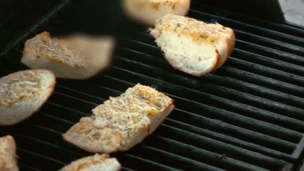 Two videos of pieces of bread on the grill in real slow motion — Stock Video