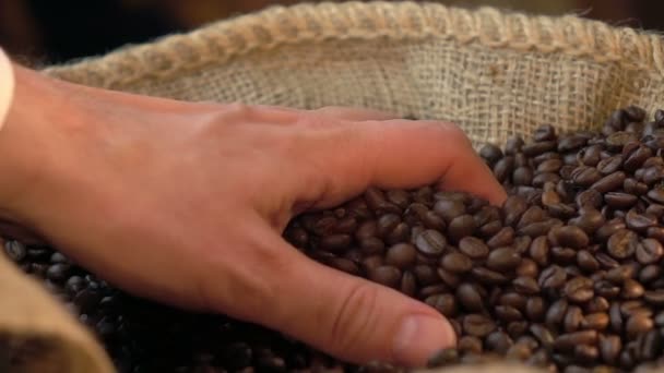 Two videos of grabbing coffee beans in real slow motion — Stock Video