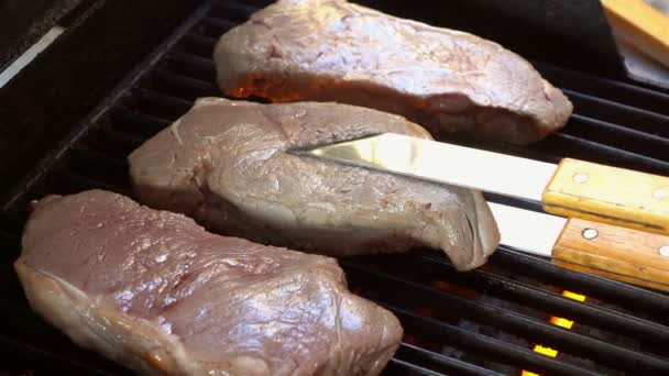 Video vom Überschlagen von Steaks auf dem Grill in echter Zeitlupe — Stockvideo