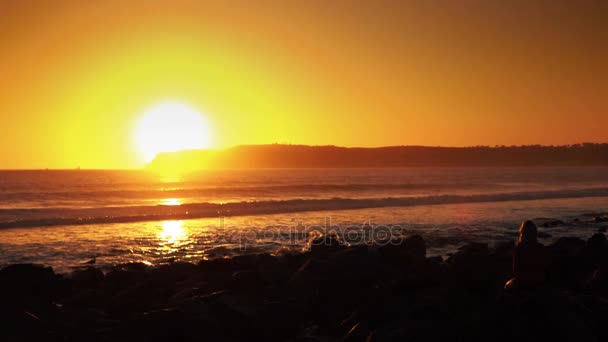 Two videos of woman looking at the sunset in real slow motion — Stock Video