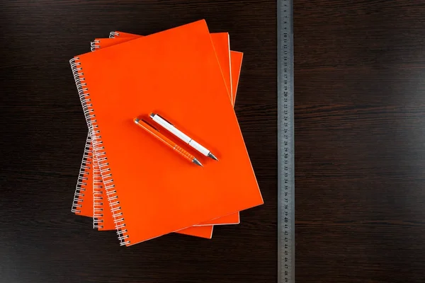 White Sketchbook Orange Notebooks Lying Dark Brown Wooden Table Orange — Stock Photo, Image