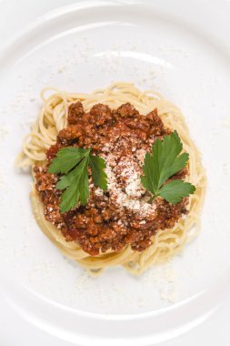 İtalyan spagetti makarna ile sığır eti ve domates sosu bolognese beyaz plaka üzerinde