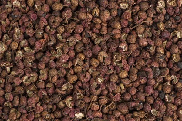 Sichuan biber arka planı. Doğal baharat dokusu. Yiyecek malzemesi..
