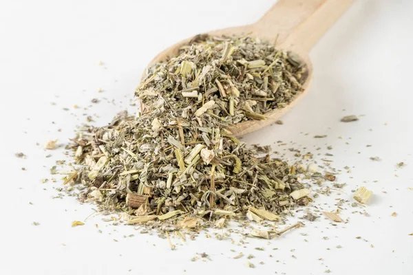 wormwood herb or in latin Absinthii herba herb in wooden spoon isolated on white background. medicinal healing herbs. herbal medicine. alternative medicine