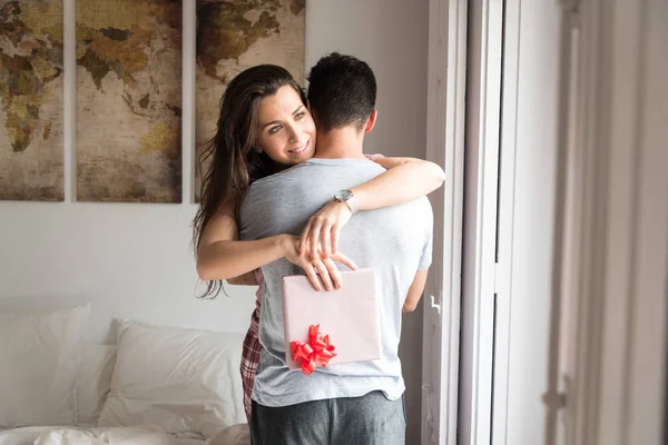 Happy young couple in love suprising each other with gifts — Stock Photo, Image