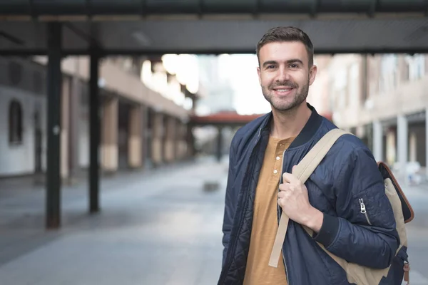 student man with backpack smiling