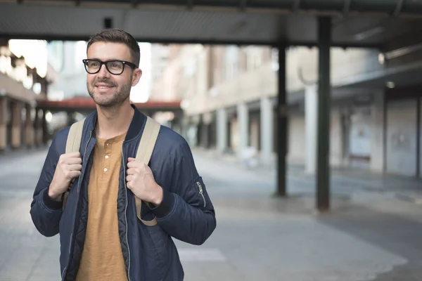 student man with backpack smiling