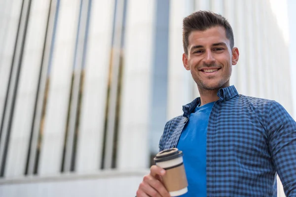 Man with a coffee on the street — Stock Photo, Image