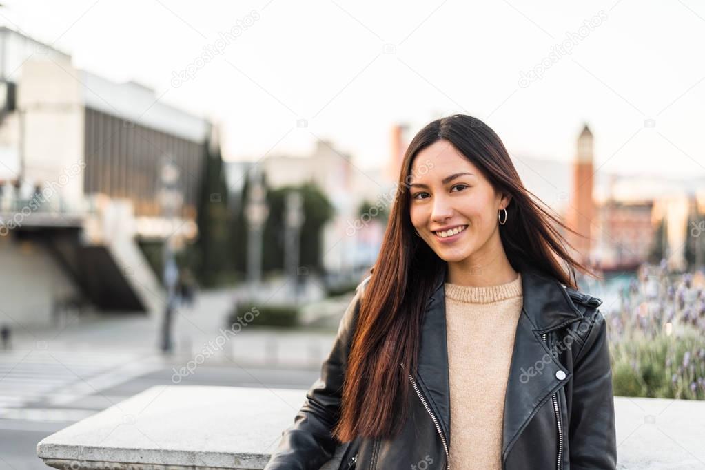 Korean young woman close-up looking at the camera smiling and ha