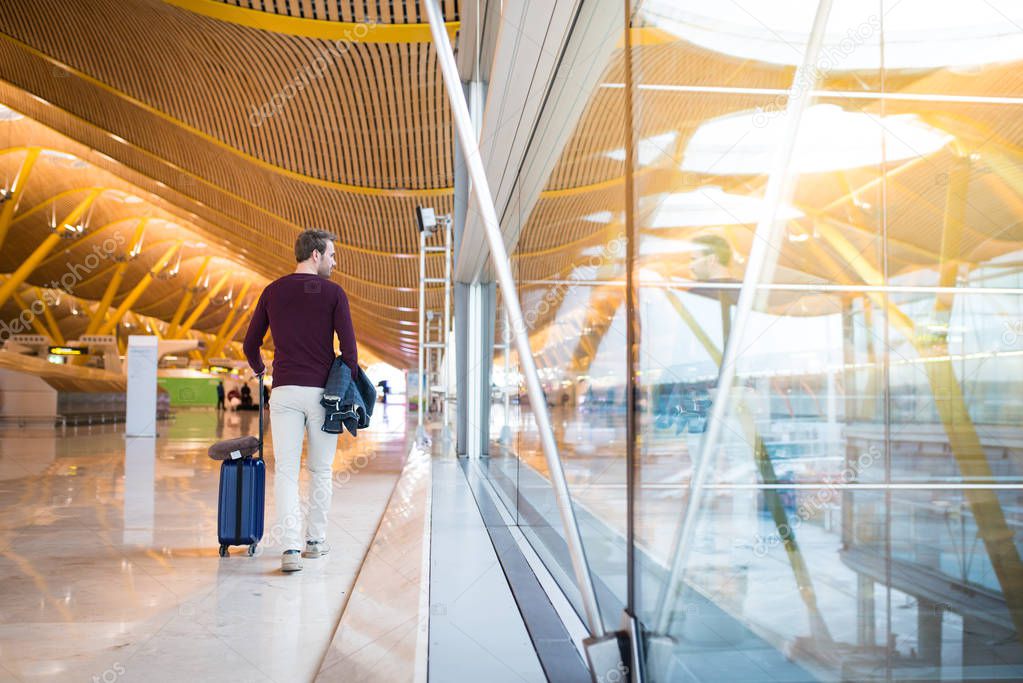 young man back walking at the airport